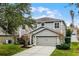 Two-story house with gray siding, attached garage, and lush green lawn at 1105 Harbor Hill St, Winter Garden, FL 34787