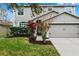 Two-story house with gray siding, attached garage, and landscaped front yard at 1105 Harbor Hill St, Winter Garden, FL 34787