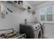 Bright laundry room features washer, dryer, and ample shelving at 1105 Harbor Hill St, Winter Garden, FL 34787