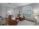 Living area with hardwood floors, leather armchairs, and a large window at 1105 Harbor Hill St, Winter Garden, FL 34787