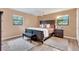 Spacious bedroom with a king-size bed and wood-look flooring at 1107 Lantana Dr, Eustis, FL 32726