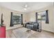 Living room with gray couch, wood flooring, and large windows at 1107 Lantana Dr, Eustis, FL 32726