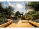 Wooden walkway provides a relaxing journey to the backyard, framed by mature trees at 11148 Lane Park Rd, Tavares, FL 32778