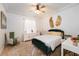 Bright bedroom with a green velvet bed frame and a sitting area at 11148 Lane Park Rd, Tavares, FL 32778