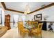 Elegant dining room featuring chandelier lighting, detailed trim and neutral decor at 11148 Lane Park Rd, Tavares, FL 32778