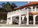 Mediterranean-style home featuring a stucco exterior, red tile roof, and a beautiful staircase with decorative railings at 11148 Lane Park Rd, Tavares, FL 32778