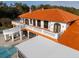 View of the rear of the house with a tiled roof and railings at 11148 Lane Park Rd, Tavares, FL 32778