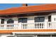 Close-up of a home showcasing architectural details such as a red tile roof and decorative window at 11148 Lane Park Rd, Tavares, FL 32778