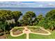 Expansive waterfront garden with a unique circular path at 11148 Lane Park Rd, Tavares, FL 32778