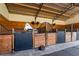 A horse in a clean stall with wood paneling and black metal enclosure at 11148 Lane Park Rd, Tavares, FL 32778