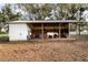 Horse stall with three horses in the stable and a dirt lot at 11148 Lane Park Rd, Tavares, FL 32778