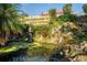 Backyard pond with statue, stone accents, and well maintained landscaping at 11148 Lane Park Rd, Tavares, FL 32778