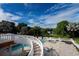 Elegant pool and spa area with spiral staircase and scenic overlook at 11148 Lane Park Rd, Tavares, FL 32778