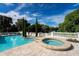 Inviting pool and spa with a tranquil view and stone patio at 11148 Lane Park Rd, Tavares, FL 32778