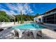 Inviting pool with spacious patio and stylish lounge chairs at 11148 Lane Park Rd, Tavares, FL 32778