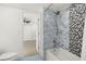 Updated bathroom with tile shower, tub, and patterned floor at 1141 Edgewood Ranch Rd, Orlando, FL 32835