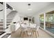 Open dining area with tile floors, modern decor, and sliding glass doors leading to an outdoor living space at 1141 Edgewood Ranch Rd, Orlando, FL 32835