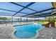 Stunning pool with covered patio and lake view at 1141 Edgewood Ranch Rd, Orlando, FL 32835