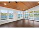 Bright sunroom with water views and wood floors at 1141 Edgewood Ranch Rd, Orlando, FL 32835