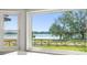 Kitchen window view of a tranquil lake and lush landscape at 1141 Edgewood Ranch Rd, Orlando, FL 32835