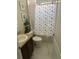 Clean bathroom with a shower/tub combo and starfish shower curtain at 115 Essex Pl, Davenport, FL 33896