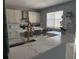 Modern kitchen with white cabinets, marble counters, and gold accents at 115 Essex Pl, Davenport, FL 33896