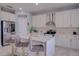 Modern kitchen with white cabinets and breakfast bar at 115 Essex Pl, Davenport, FL 33896