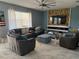 Spacious living room with sectional sofa and large TV at 115 Essex Pl, Davenport, FL 33896