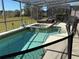 Screened pool and spa with patio furniture at 115 Essex Pl, Davenport, FL 33896