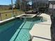 Screened pool and spa with patio furniture at 115 Essex Pl, Davenport, FL 33896