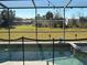 Screened-in pool with safety fence and backyard view at 115 Essex Pl, Davenport, FL 33896