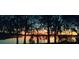 Stunning sunset view over a serene lake, framed by majestic trees at 1174 Paseo Del Mar # D # 32707, Casselberry, FL 32707