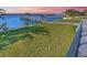 Expansive grassy backyard with a private dock and access to the water at 118 River Ln, Ormond Beach, FL 32176