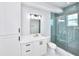 Modern bathroom with a walk-in shower and white cabinets at 118 River Ln, Ormond Beach, FL 32176