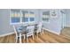 Bright dining room with water views and a rustic table at 118 River Ln, Ormond Beach, FL 32176