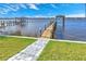 Private wooden dock extending over calm water, offering boat access at 118 River Ln, Ormond Beach, FL 32176