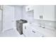 Laundry room with white cabinets and modern appliances at 118 River Ln, Ormond Beach, FL 32176