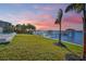 Stunning sunset view over the water, private dock, and lush landscaping at 118 River Ln, Ormond Beach, FL 32176