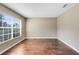 Bedroom featuring a window with views and hardwood flooring throughout at 13132 Coldwater Loop, Clermont, FL 34711