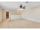 Open bonus room area with carpet, ceiling fan, and a view to the bathroom at 13132 Coldwater Loop, Clermont, FL 34711