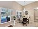 Lovely dining area with a crystal chandelier and a view to the outdoor pool area at 13132 Coldwater Loop, Clermont, FL 34711