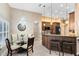 Charming dining area featuring a crystal chandelier, tile floors, and a bright window at 13132 Coldwater Loop, Clermont, FL 34711