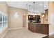 Cozy dining area with tile floors, a crystal chandelier, and a view to the kitchen at 13132 Coldwater Loop, Clermont, FL 34711