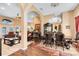 Elegant dining room with chandelier and hardwood floors, adjacent to living area at 13132 Coldwater Loop, Clermont, FL 34711