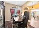 Formal dining room featuring hardwood floors, elegant chairs and windows with drapes at 13132 Coldwater Loop, Clermont, FL 34711