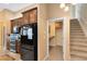 View of kitchen area highlighting stainless appliances, tile flooring, a built-in desk, and staircase at 13132 Coldwater Loop, Clermont, FL 34711