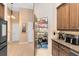 Kitchen area showing the pantry, tile floors, and cabinets at 13132 Coldwater Loop, Clermont, FL 34711