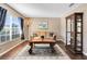 Living room with decorative rug, lamp, sofa and display cabinet at 13132 Coldwater Loop, Clermont, FL 34711