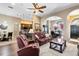 Spacious living room with leather sofas, a view into kitchen and dining areas at 13132 Coldwater Loop, Clermont, FL 34711