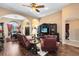 Open living area with leather seating, hardwood floors, and views to dining area at 13132 Coldwater Loop, Clermont, FL 34711